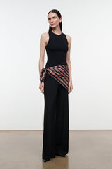 Silk scarf with multicolor geometric stripe pattern wrapped at waist with black dress