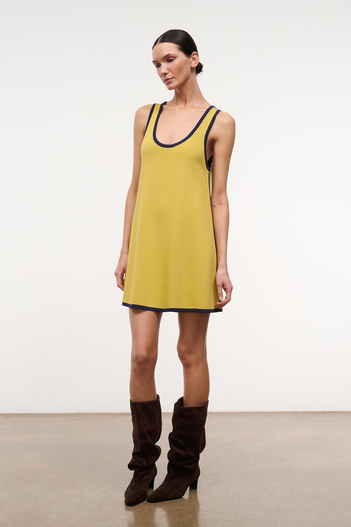 Brown suede slouch boots with stacked heel and ruched shaft on model