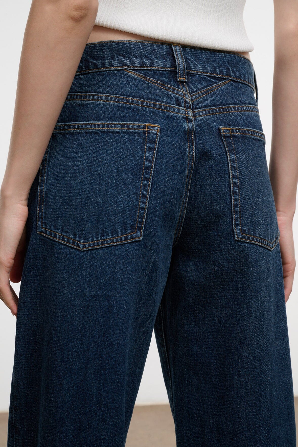 Relaxed dark-wash jeans with two rear patch pockets and contrast topstitching