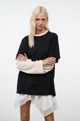 Black oversized tee with short sleeves and ecru long sleeves; straight hemline