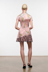 Pink silk dress with short sleeves, floral print, and flared tiered hem