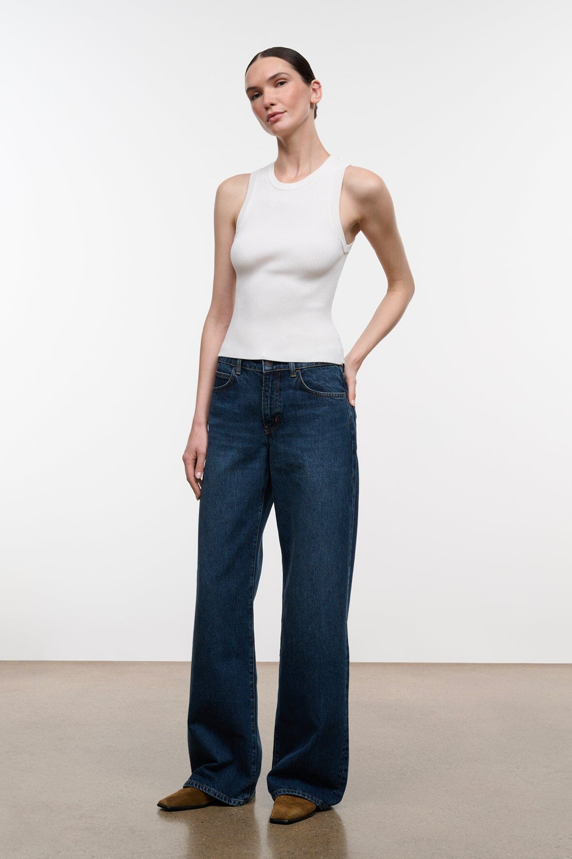 Relaxed dark-wash jeans with wide-leg cut and front patch pockets, belt loops