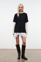 Black oversized tee with short sleeves, ecru long-sleeve layer peeking at sides