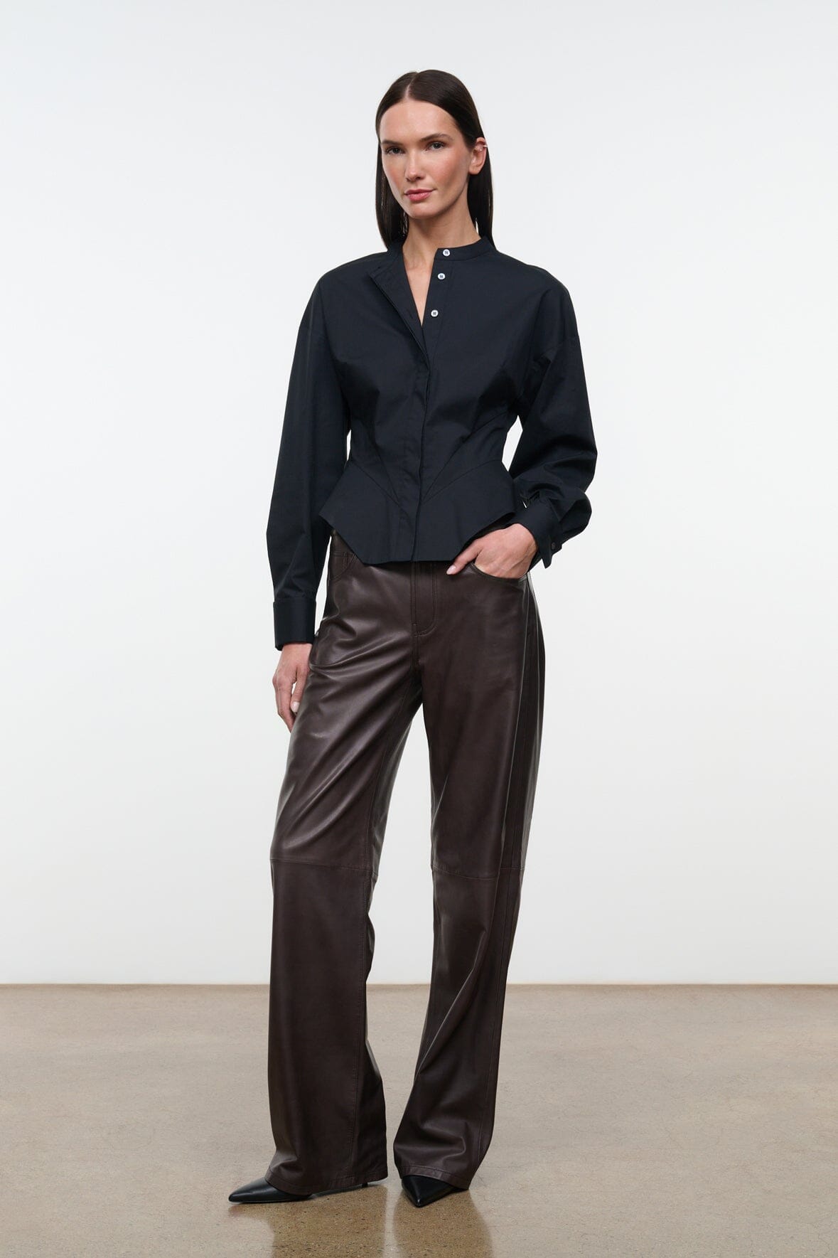 Black stand-collar button top with long sleeves and layered peplum hem