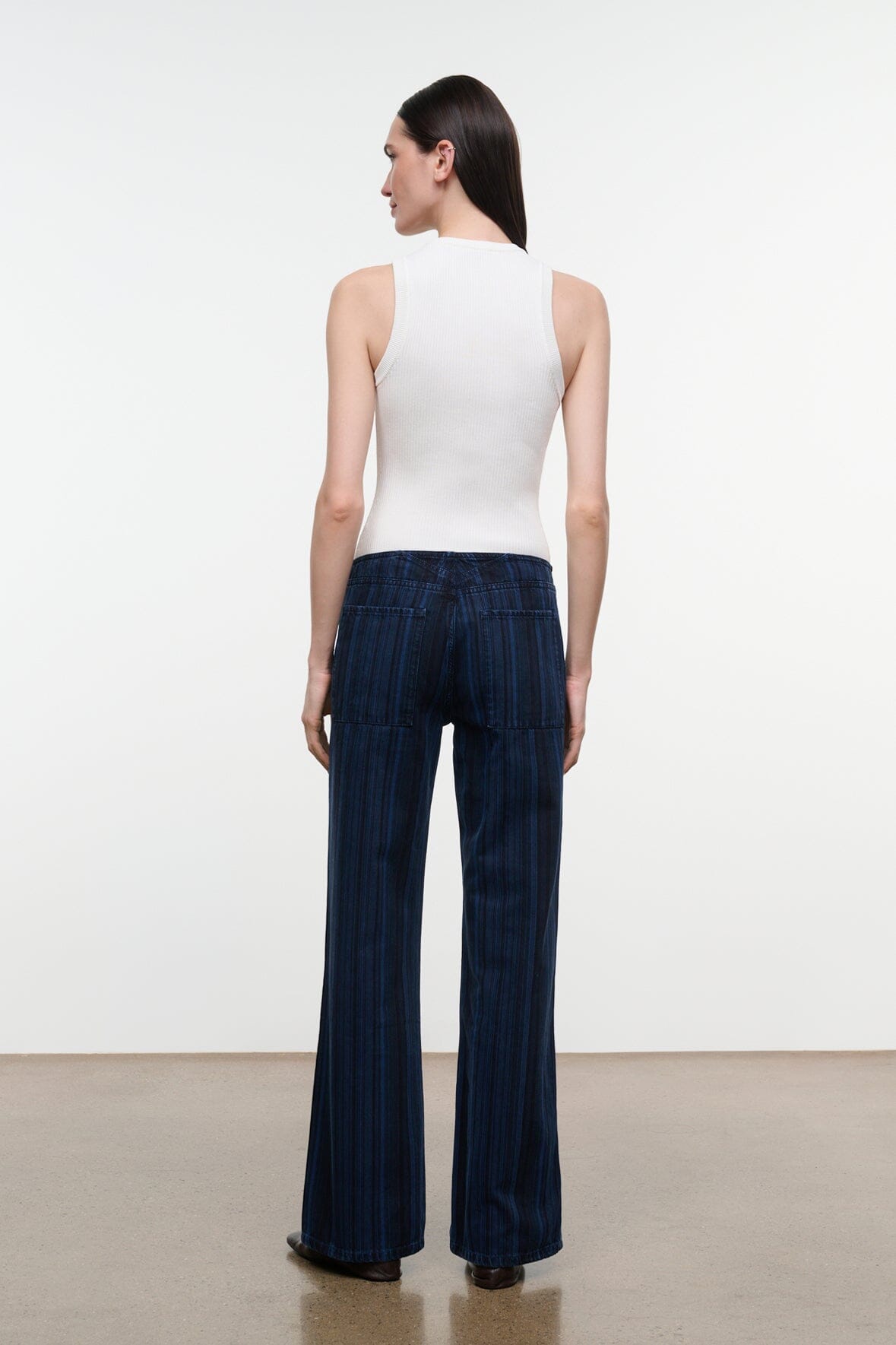 Women's dark navy striped wide-leg jeans, back view with pull-on waistband and wide straight legs