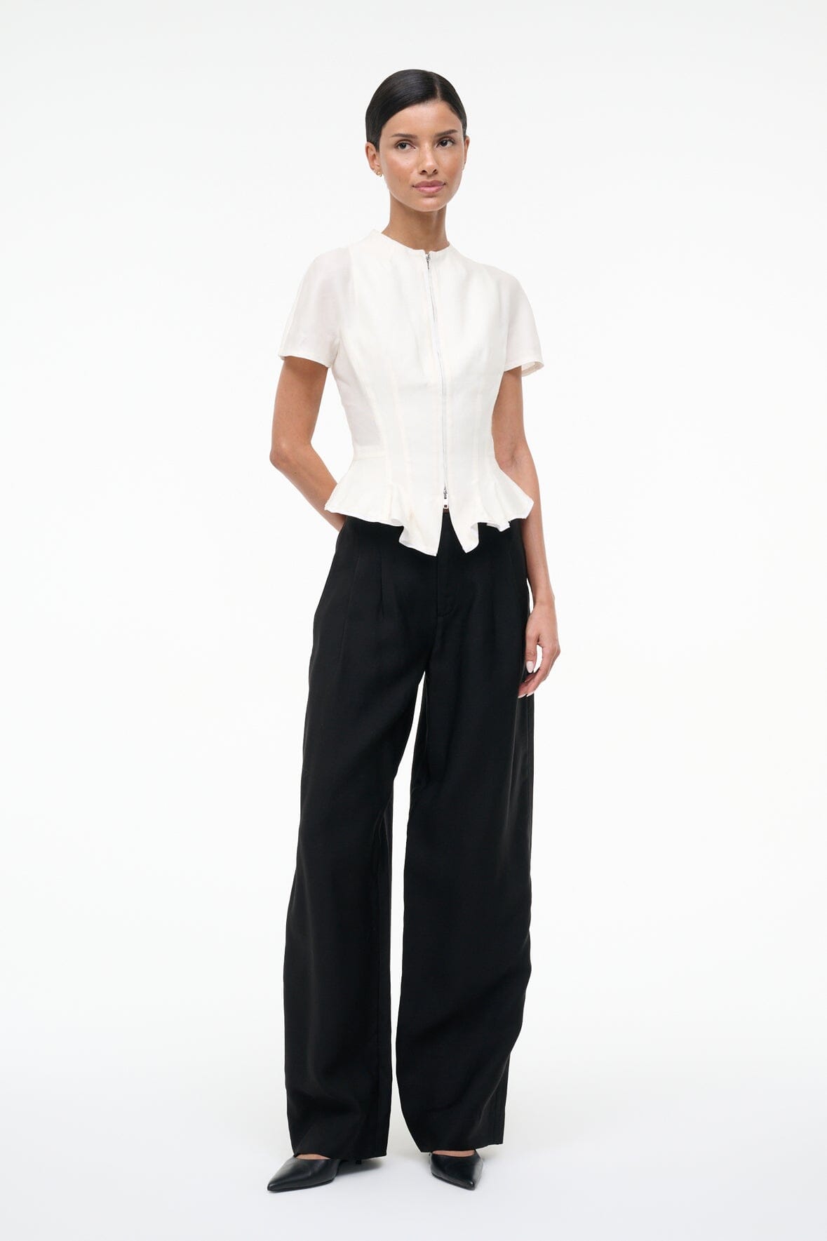 Ivory short-sleeve peplum top with center zipper and flared back hem