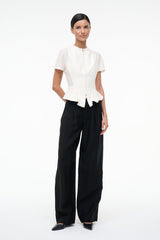 Ivory short-sleeve peplum top with center zipper and flared back hem