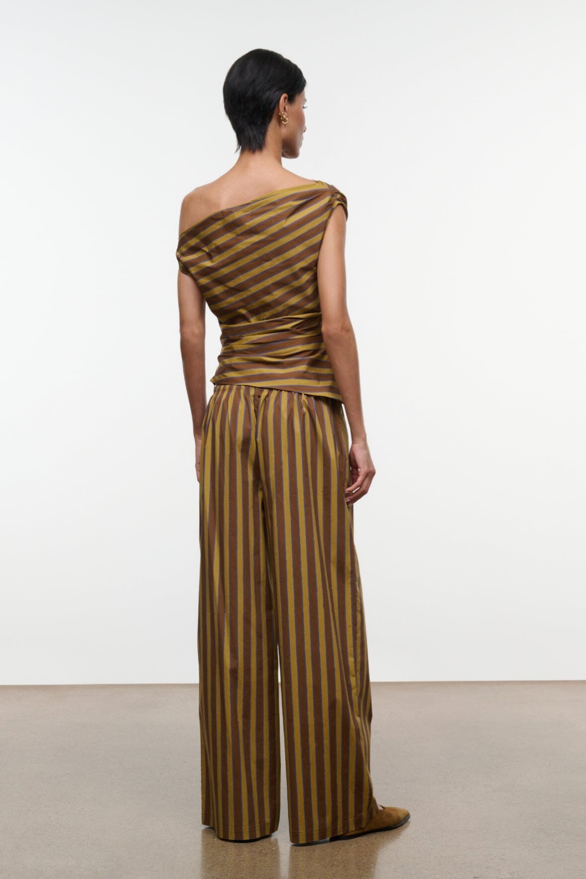 Back view wide-leg striped pants with drawstring waist, vertical brown and teal stripes