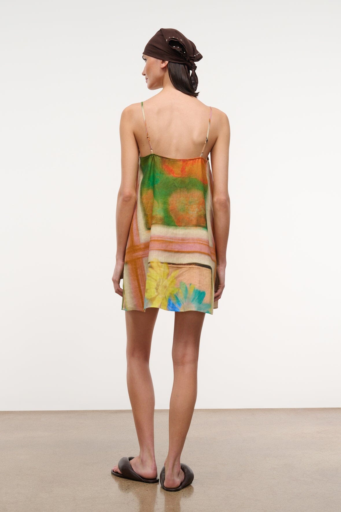 Back view multicolor floral linen mini dress with thin spaghetti straps and open back