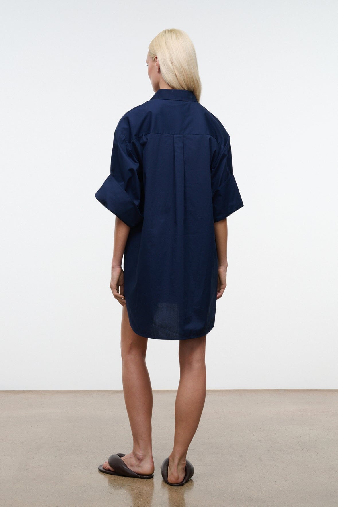 Back view of navy shirt dress with collar and short wide sleeves