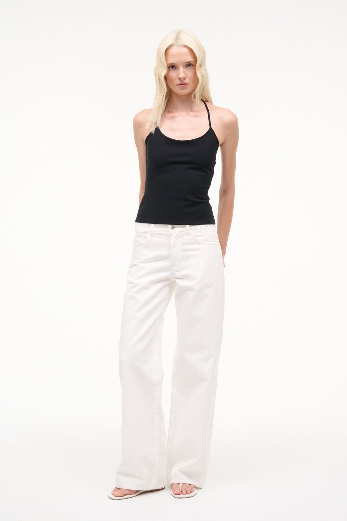 Black cami-style tank top with thin straps and straight hem