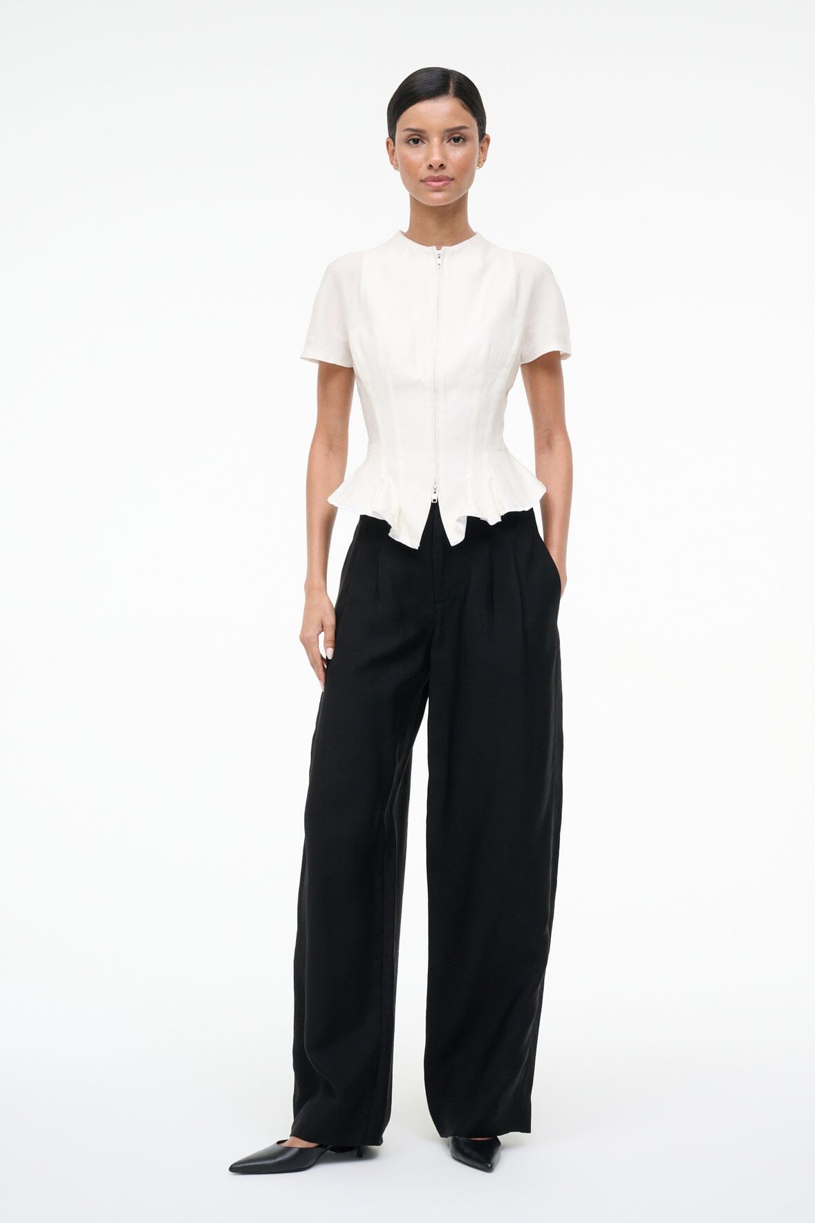 Ivory peplum top with short sleeves and center-front zipper, asymmetric hem