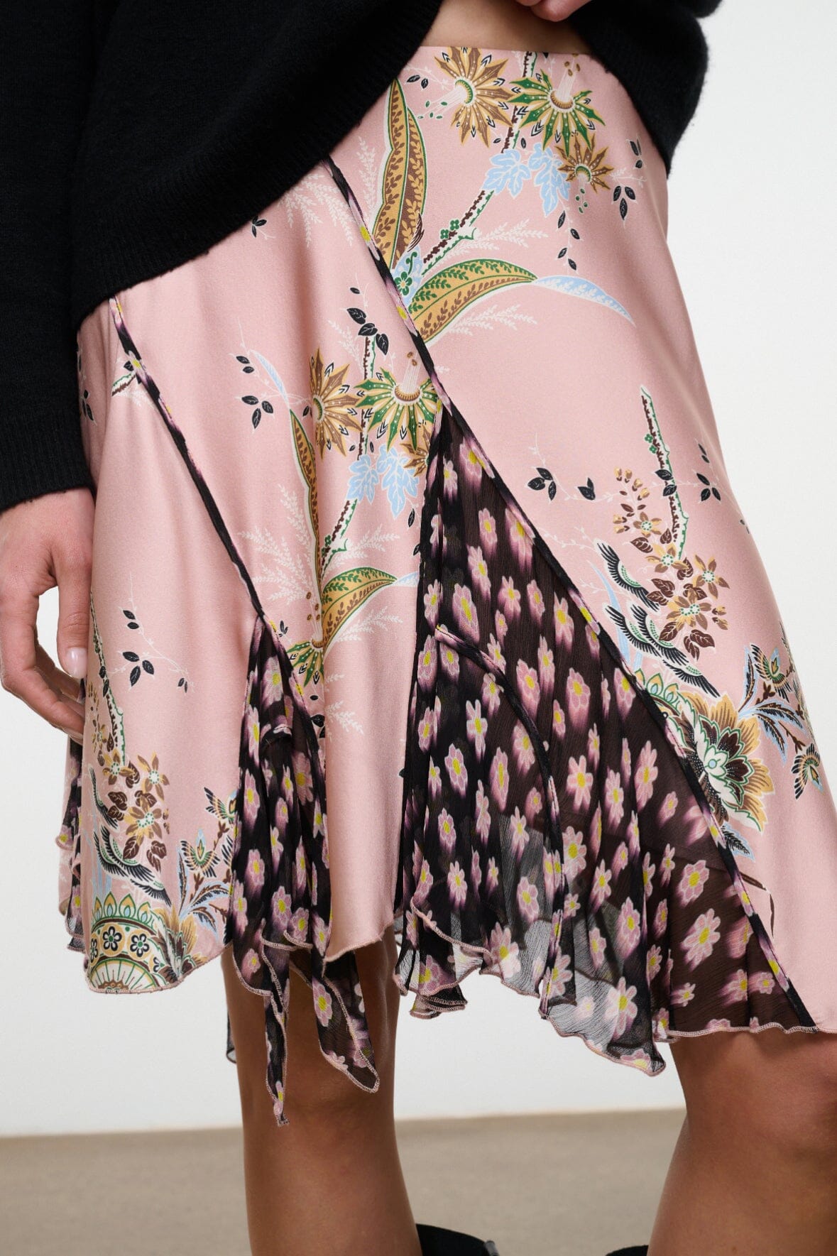 Pink silk skirt with black and green floral tapestry print, draped mid-length hem