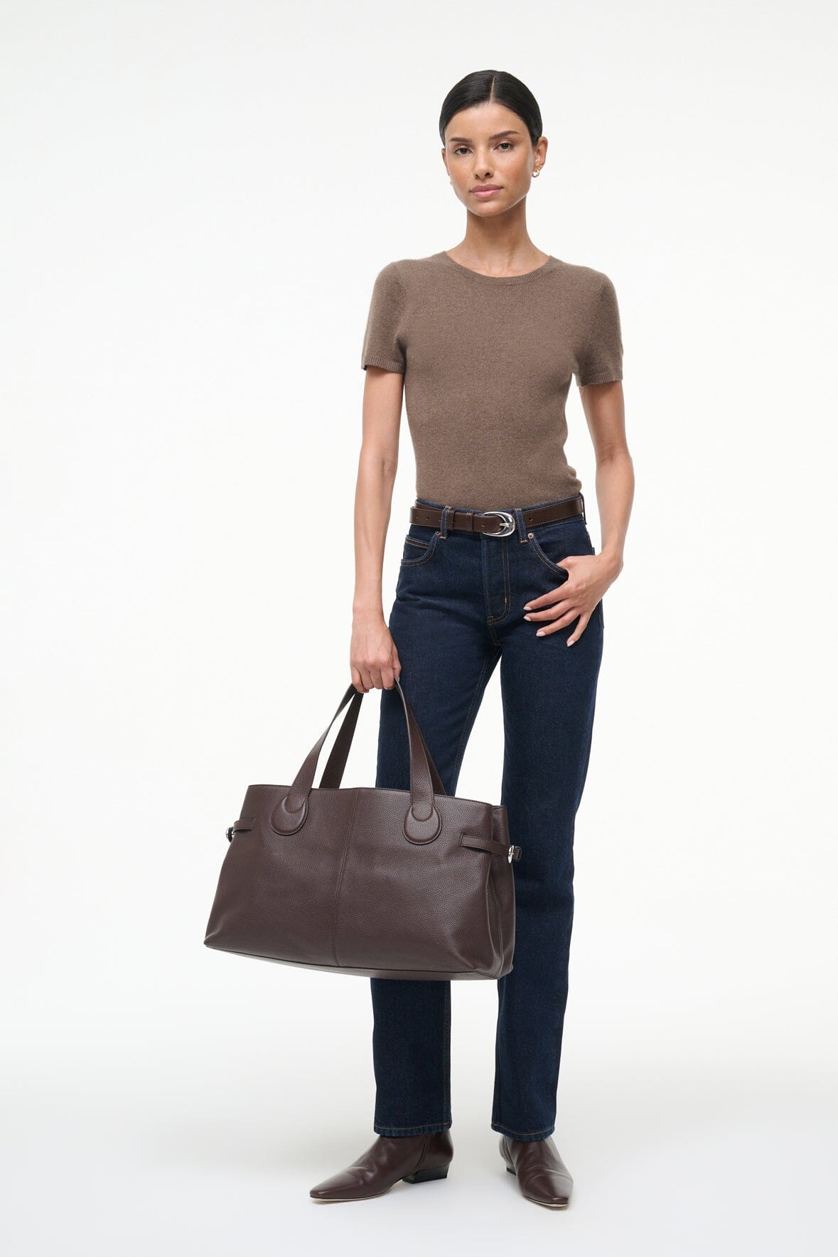 Espresso-brown tote bag with top zip and two handles, worn by model