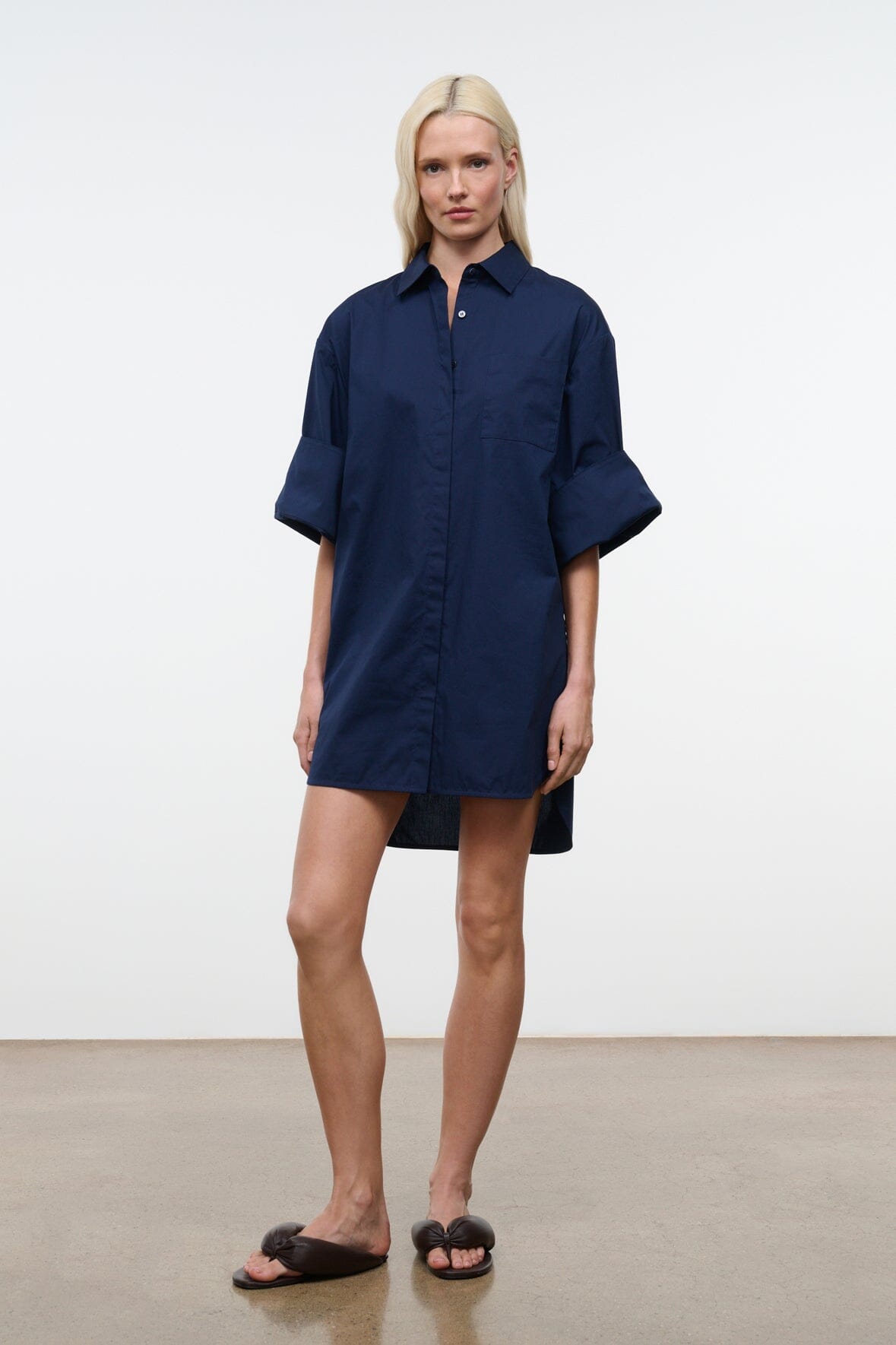 Navy shirt dress with collar, button placket, and above-knee hem