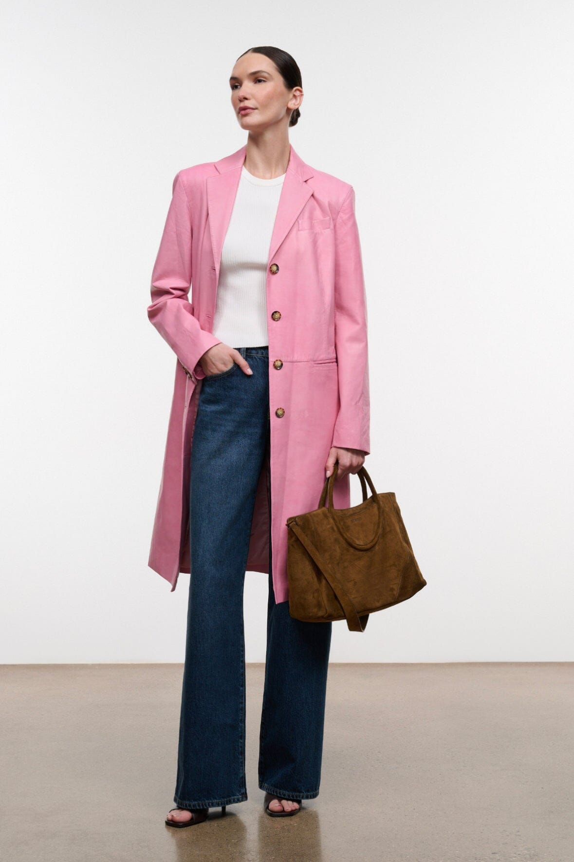 Pink leather leather coat with gold-tone buttons and long sleeves, worn open