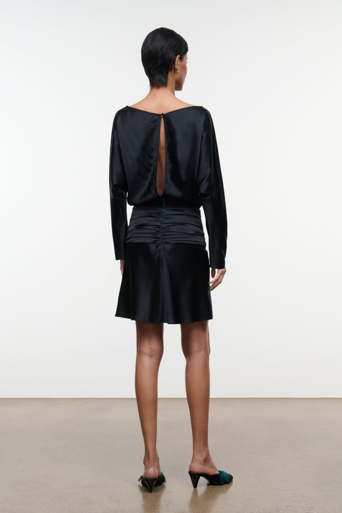 Black silk mini dress with long sleeves, ruched back detail