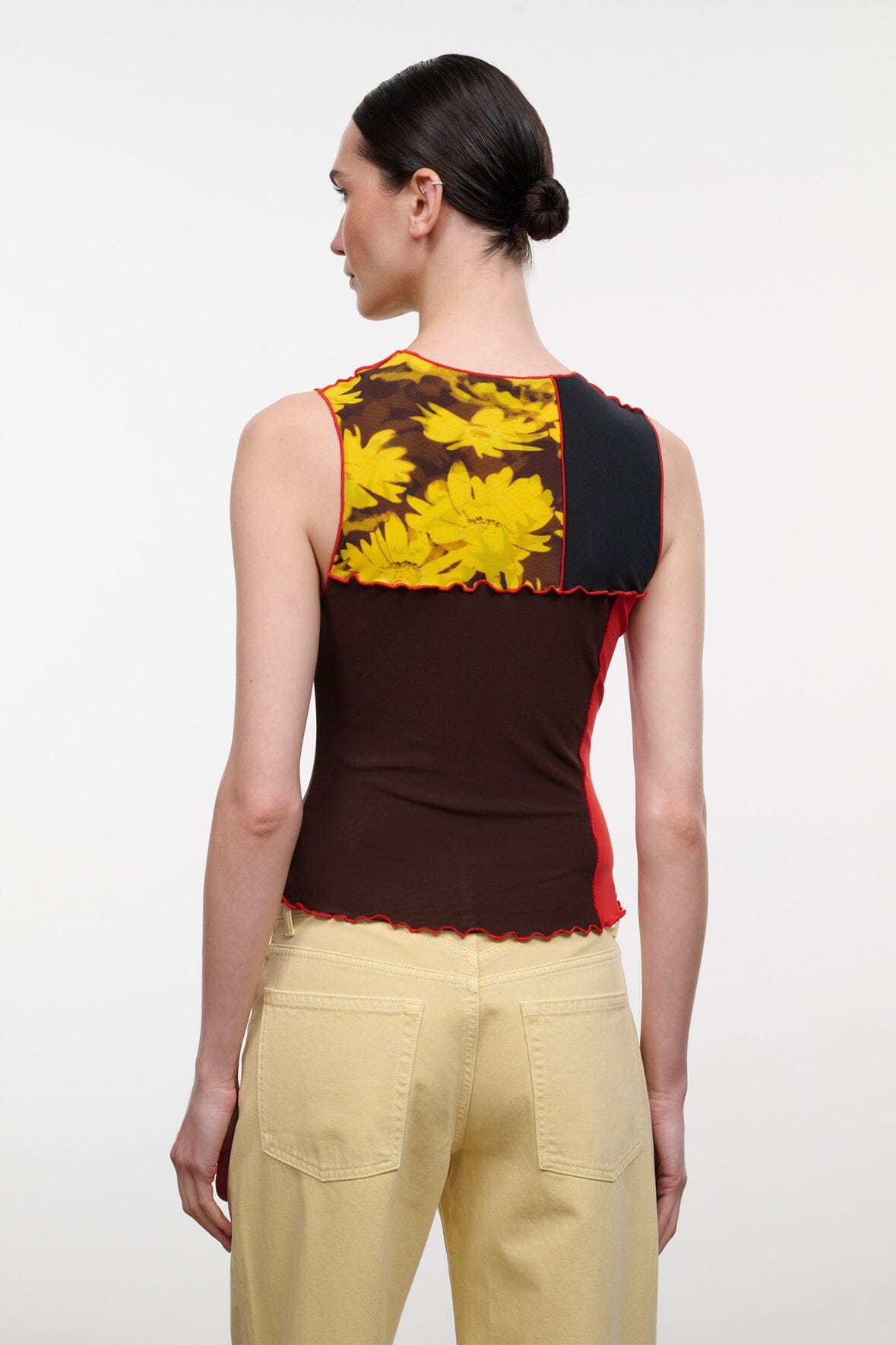 Sleeveless patchwork floral top with dark brown base, yellow blooms, red trim, back view