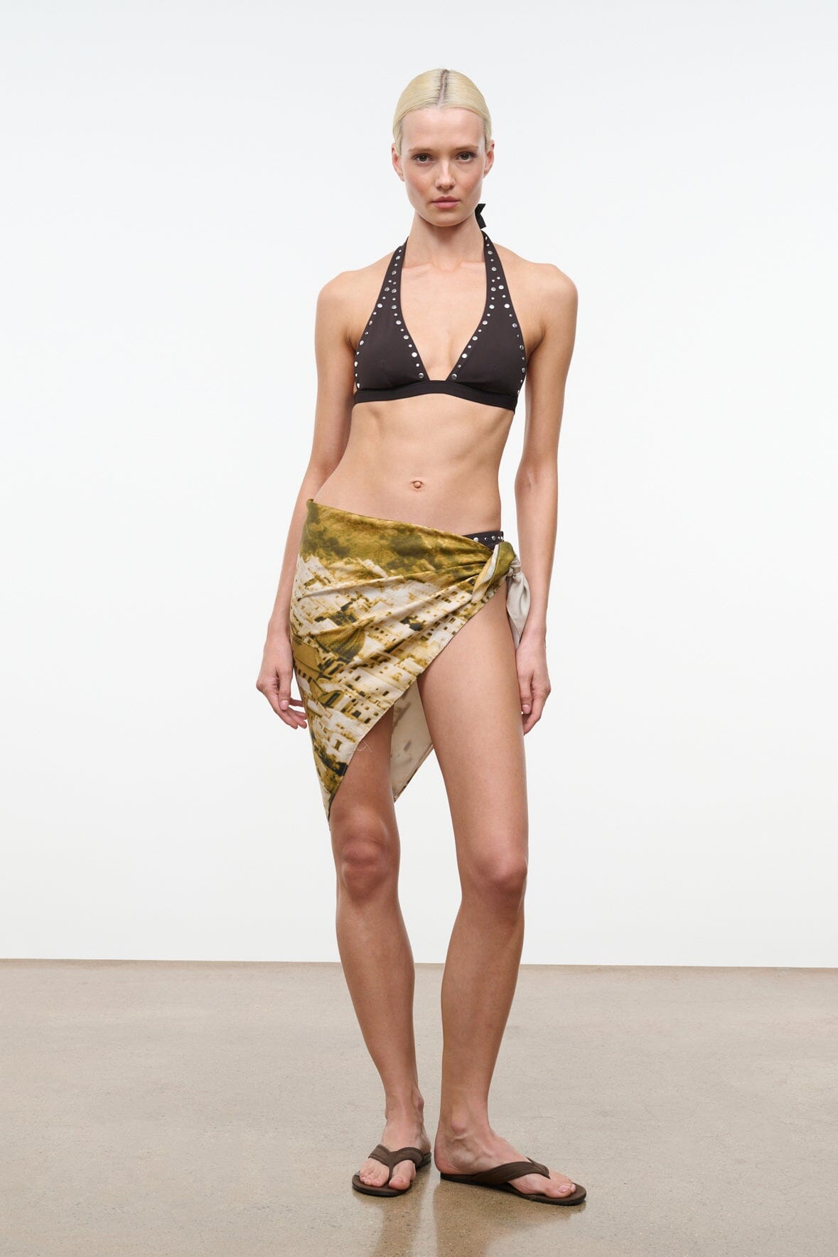 Silk scarf in olive and gold abstract print, draped and tied at the hip