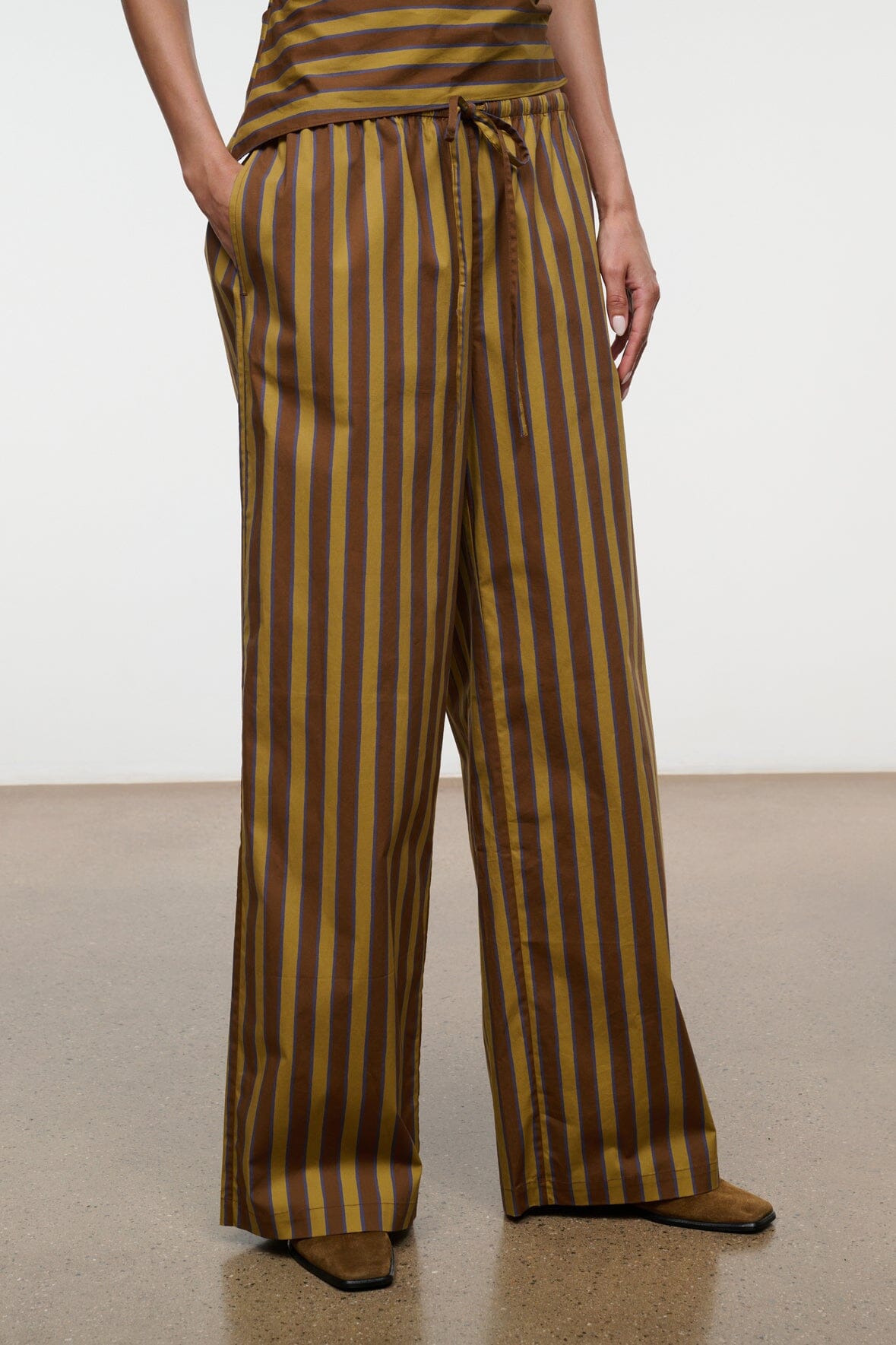 Wide-leg striped pants with drawstring waist and straight cuffs, vertical brown and teal stripes