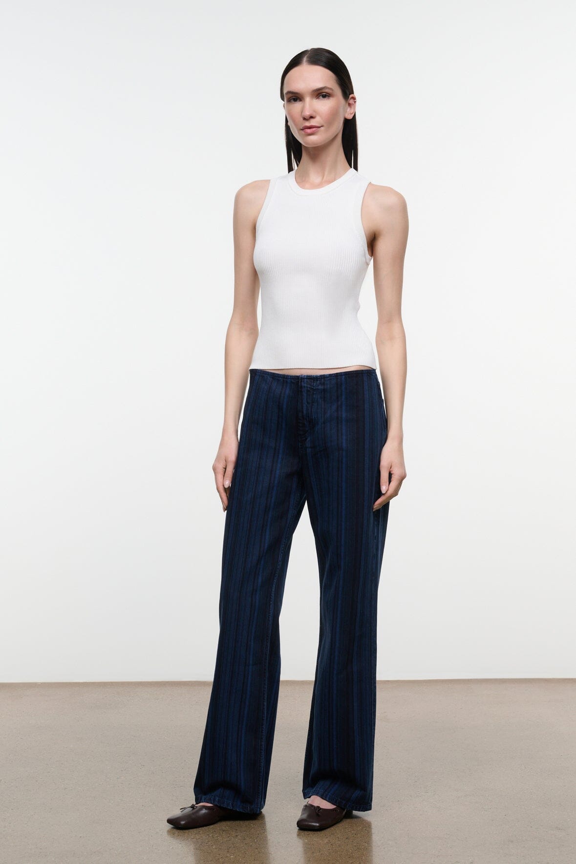 Women's dark navy striped wide-leg jeans, front view standing with straight wide pant legs