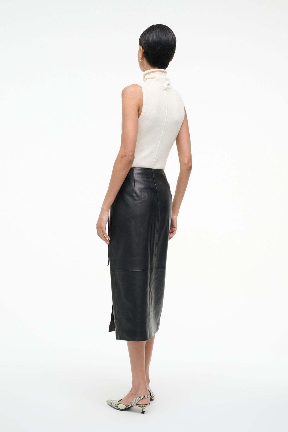 Black leather wrap midi skirt, back view with center seam and waist tie