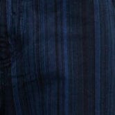 Close-up of dark navy striped denim fabric with vertical and subtle stitched texture