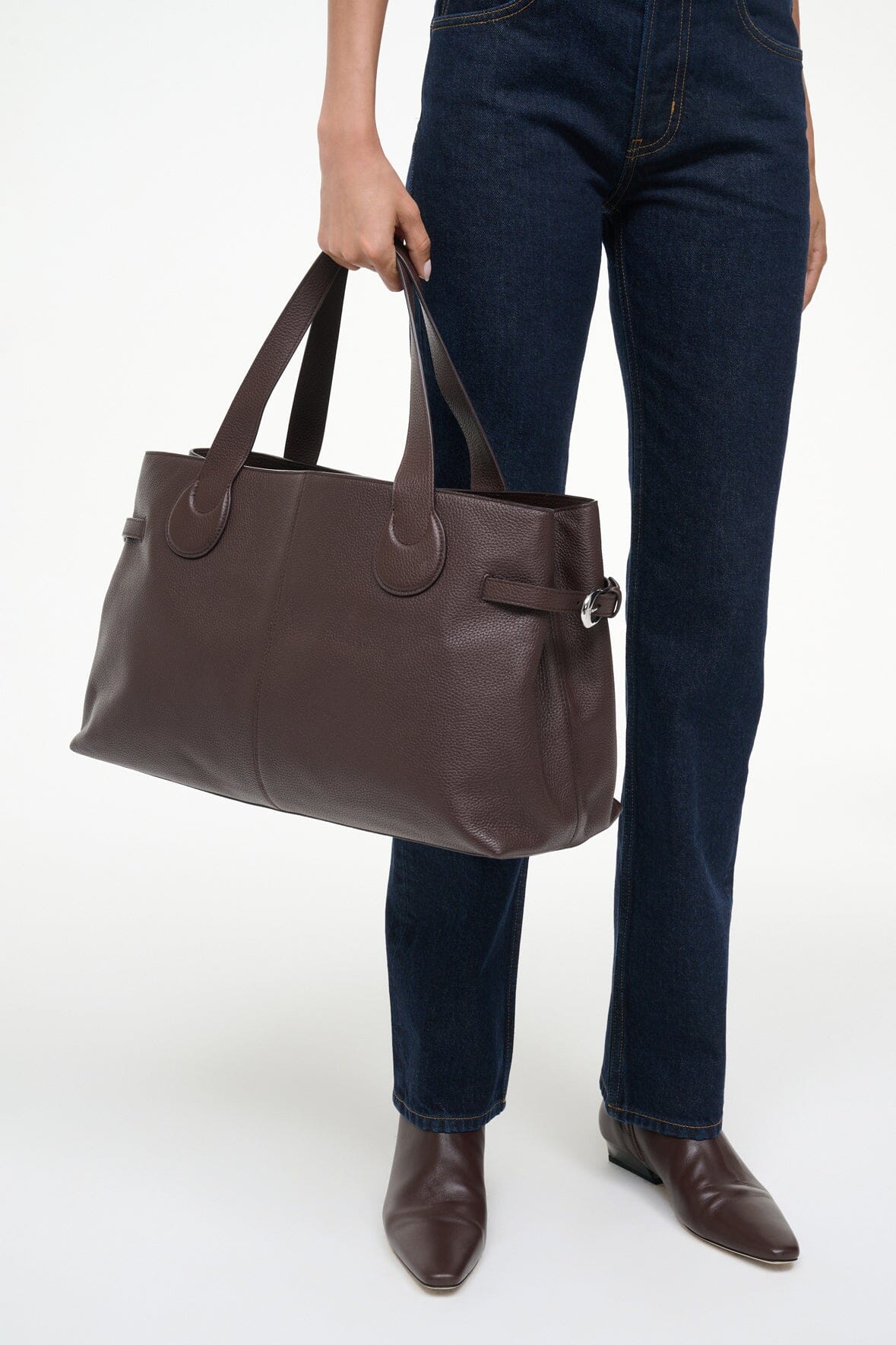 Espresso-brown tote bag with top handles and front zip pull detail
