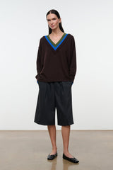 Black flat ballet shoes worn with dark culottes, pointed toe and bow