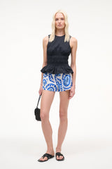 Black sleeveless peplum top with gathered waist and round neckline.