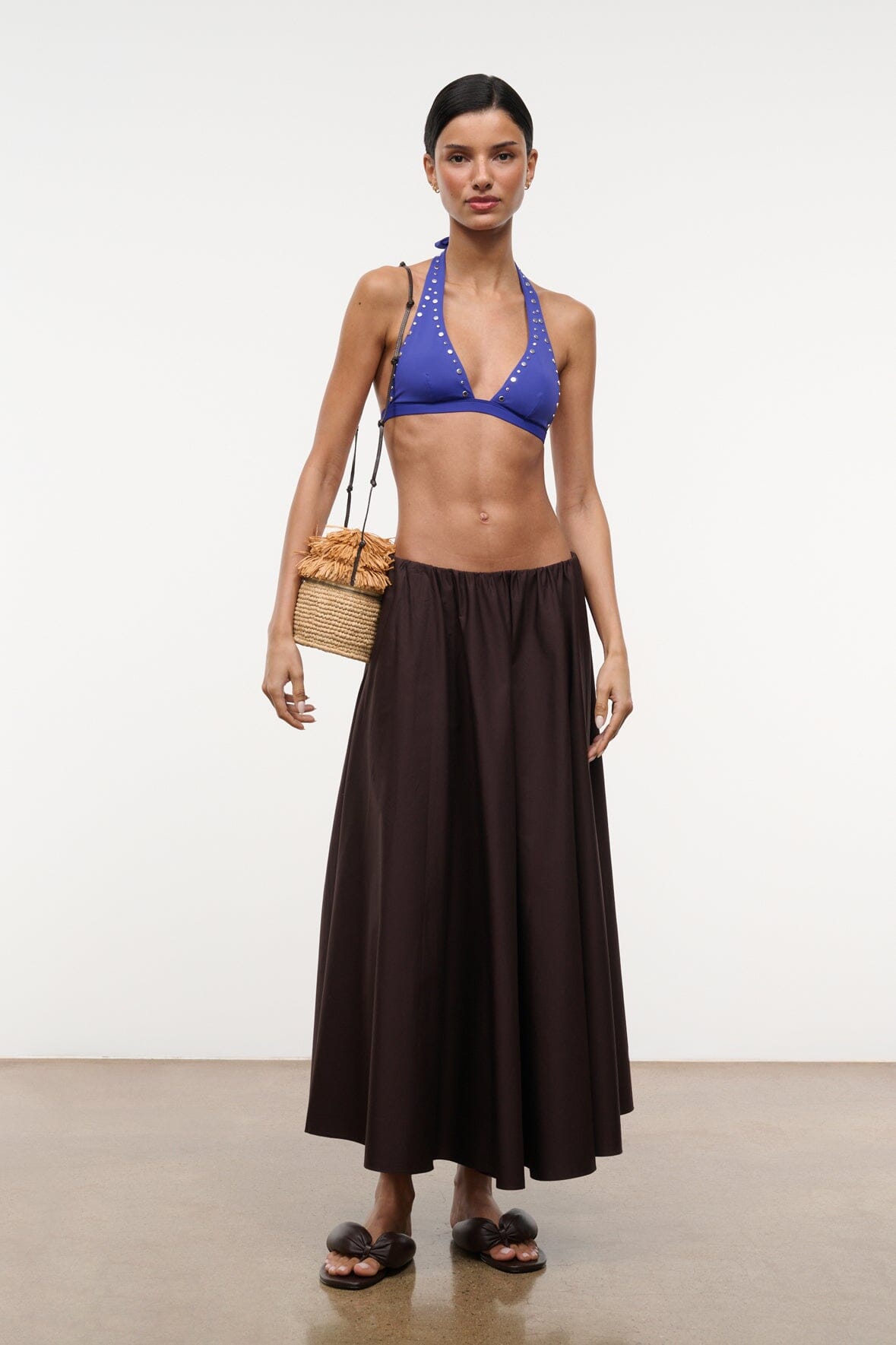 Dark brown maxi skirt with gathered waist and pleated full skirt, side view