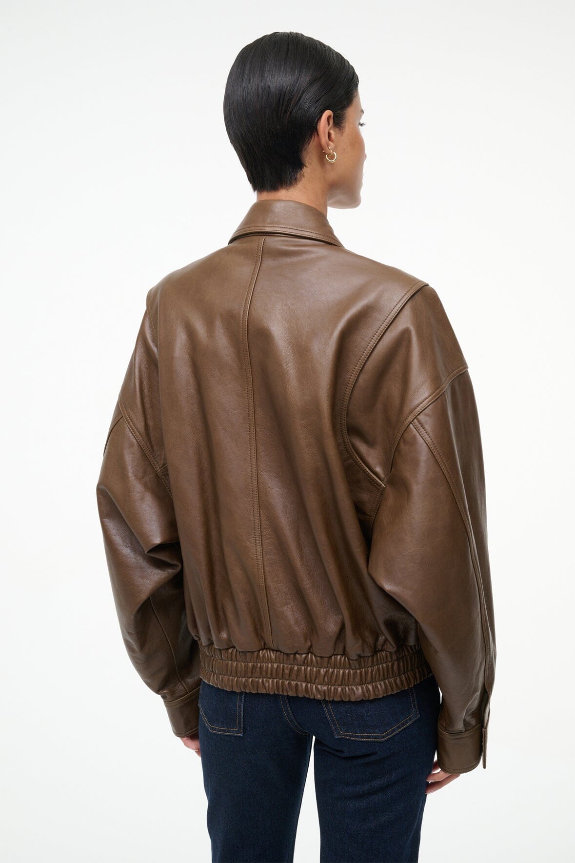 Back view brown leather bomber jacket with yoke seams and ribbed hem