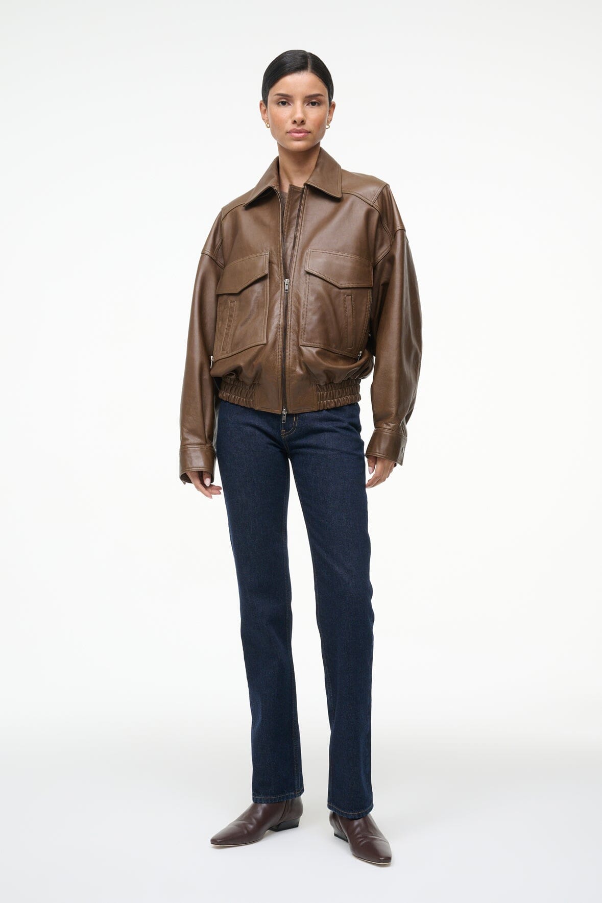 Brown leather bomber jacket with stand collar, zip front, and chest flap pockets