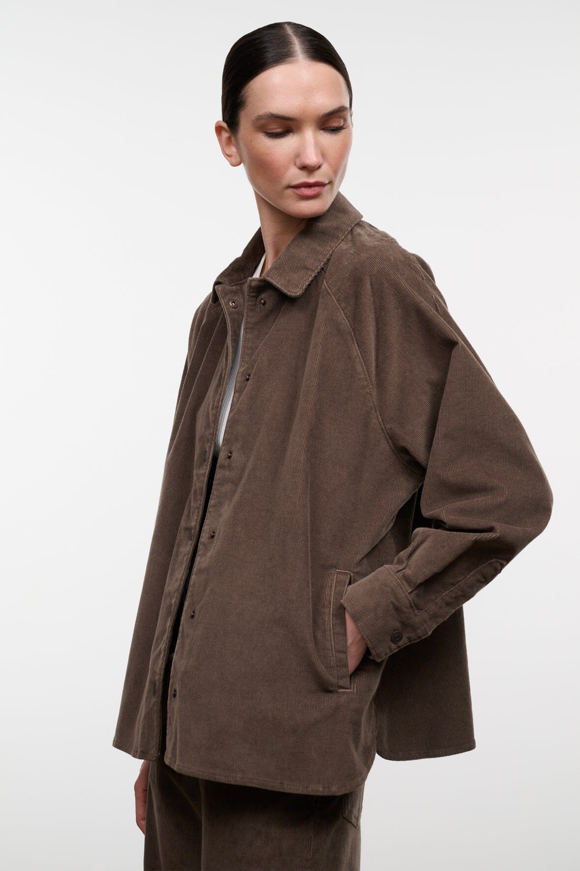 Brown corduroy shirt jacket with pointed collar and side flap pocket