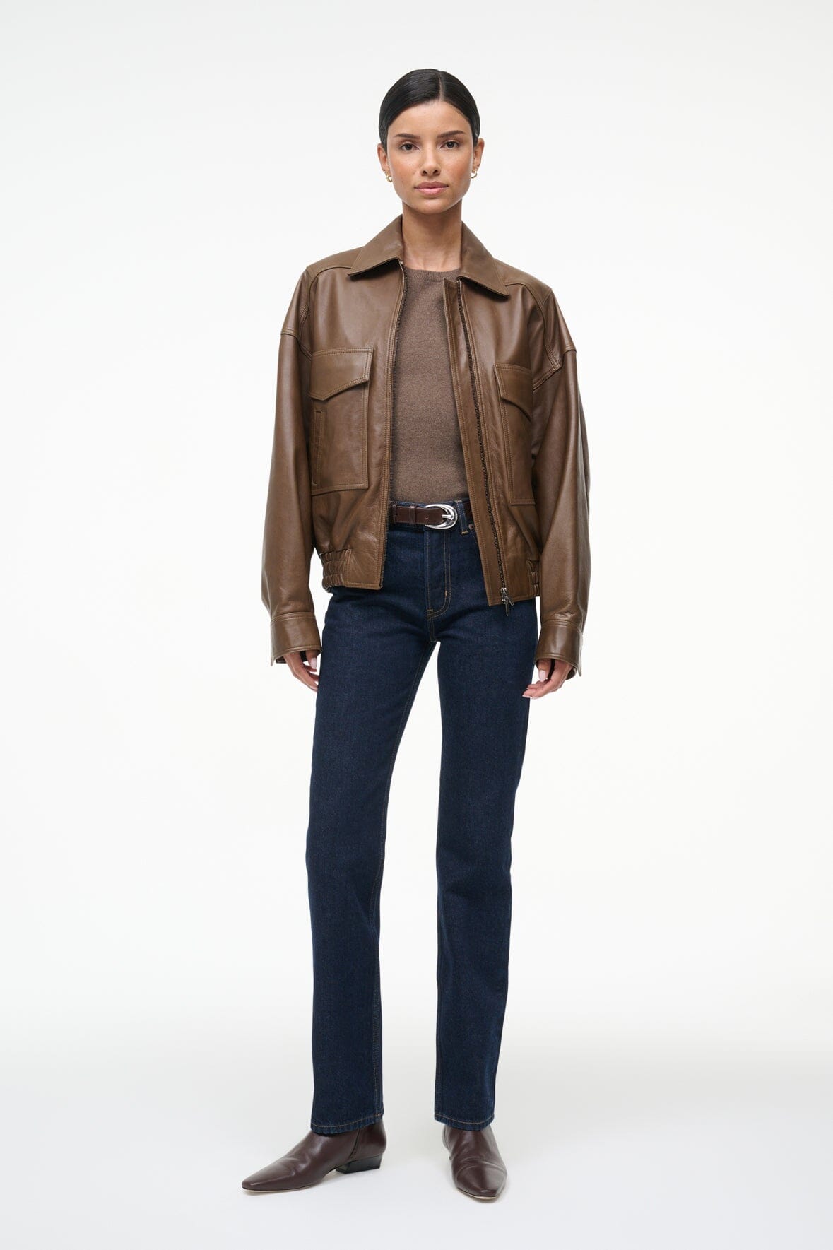 Brown leather bomber jacket with zip front, flap pockets, and elastic waist