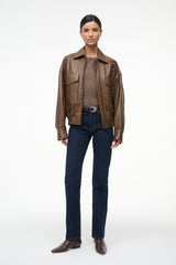 Brown leather bomber jacket with zip front, flap pockets, and elastic waist