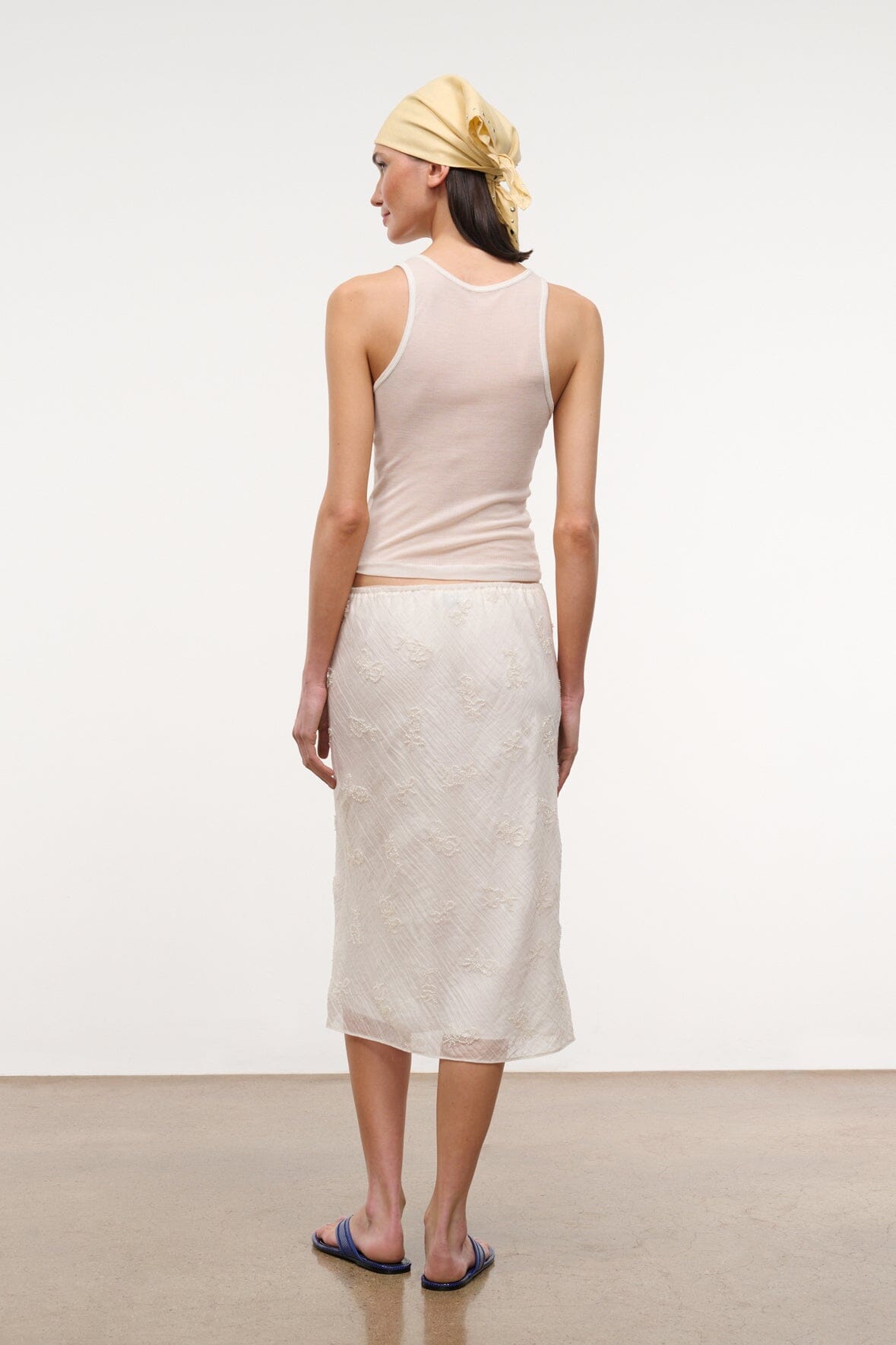 Ivory ribbed racerback tank top, back view with small hem detail