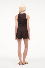 Dark brown sleeveless V-neck romper with belted waist and short shorts