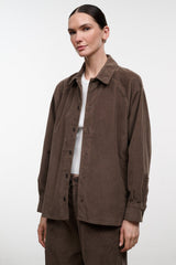 Brown corduroy shirt jacket worn open over a white crewneck
