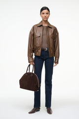 Women’s brown leather bomber jacket with front zipper and flap chest pockets