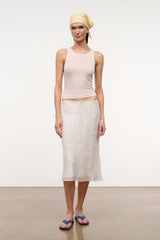 Ivory ribbed tank top with delicate front embroidery, worn with skirt