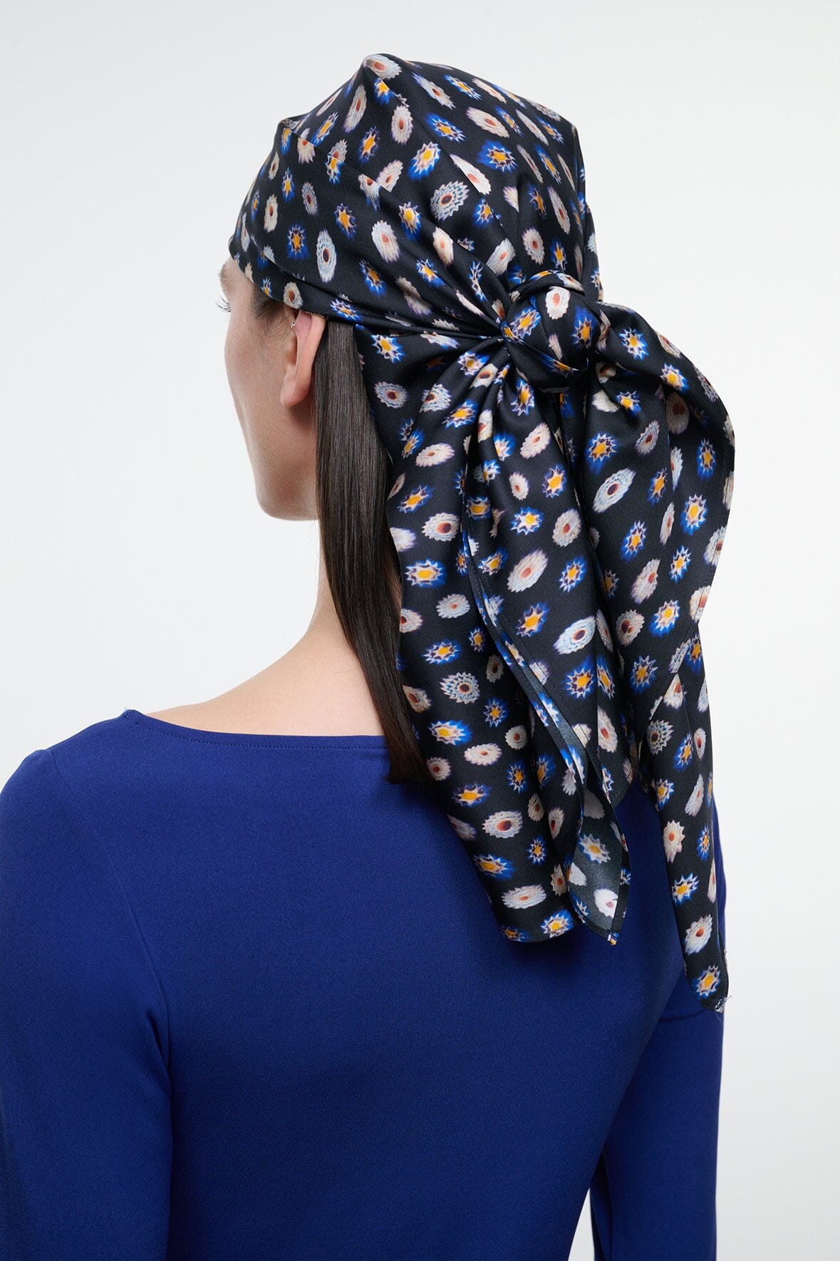 Silk scarf headwrap with navy multicolor circle print and large bow knot, draped