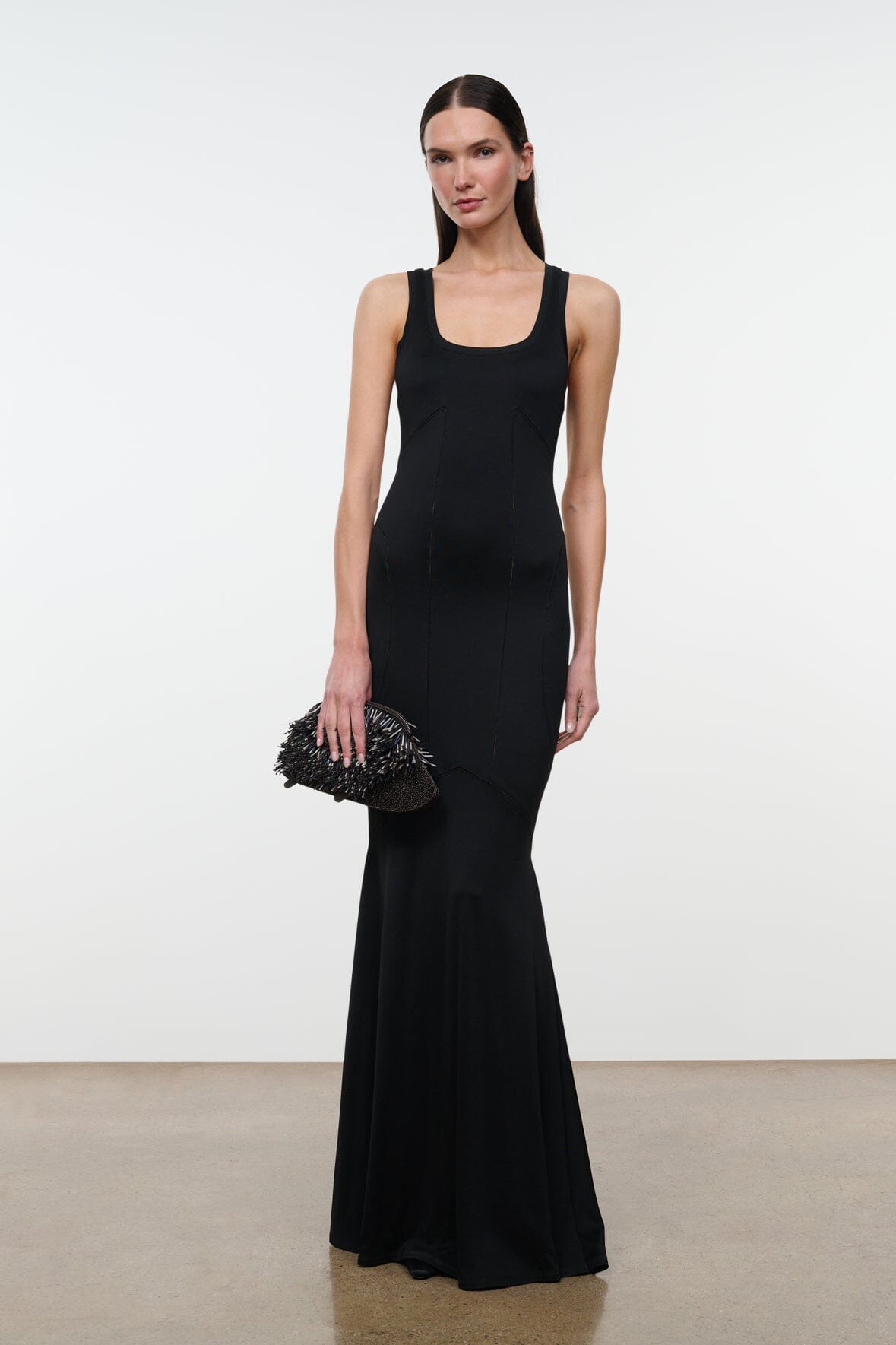Black sleeveless maxi dress with scoop neck, thin straps, fitted bodice and fluted hem