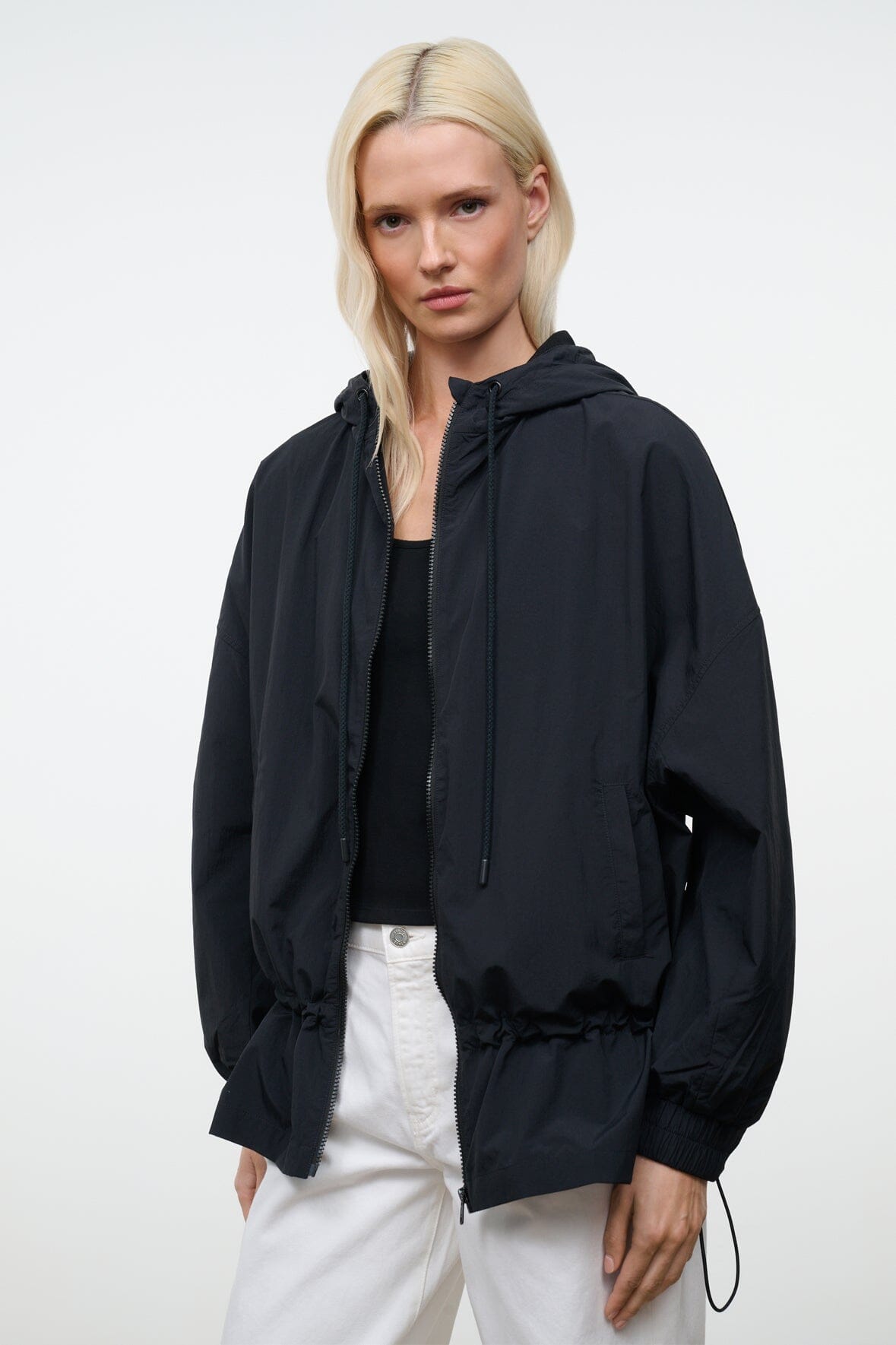 Black hooded jacket front with zip closure, drawstring hood, and side pocket opening.