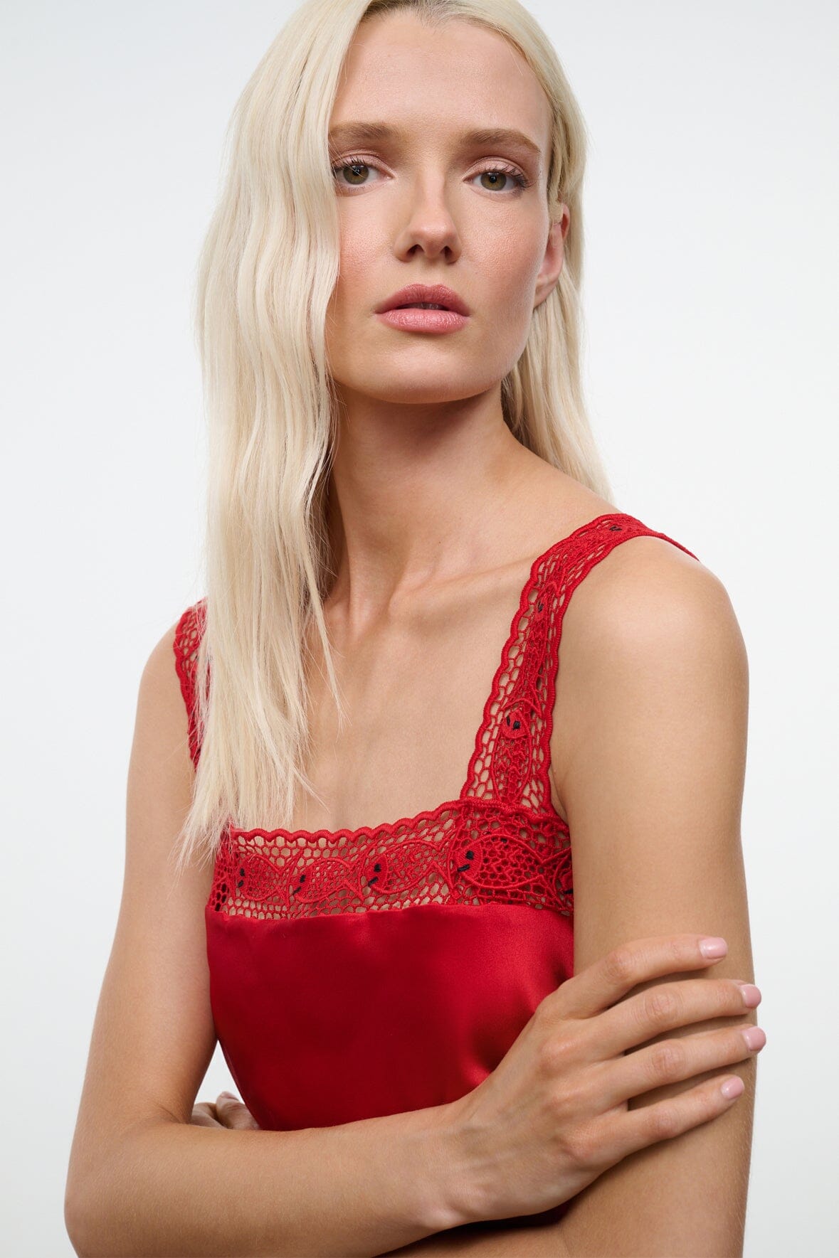 Tomato red silk cami top close-up with lace scoop neckline and thin lace straps