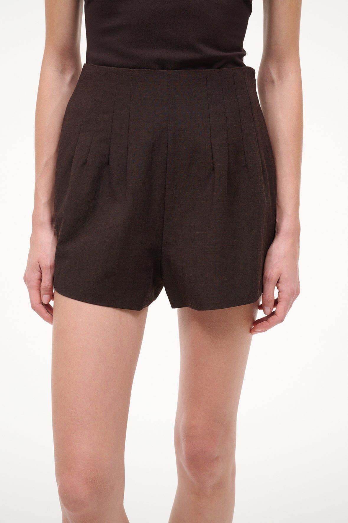 Dark brown high-waist shorts with front pleats and straight, relaxed legs