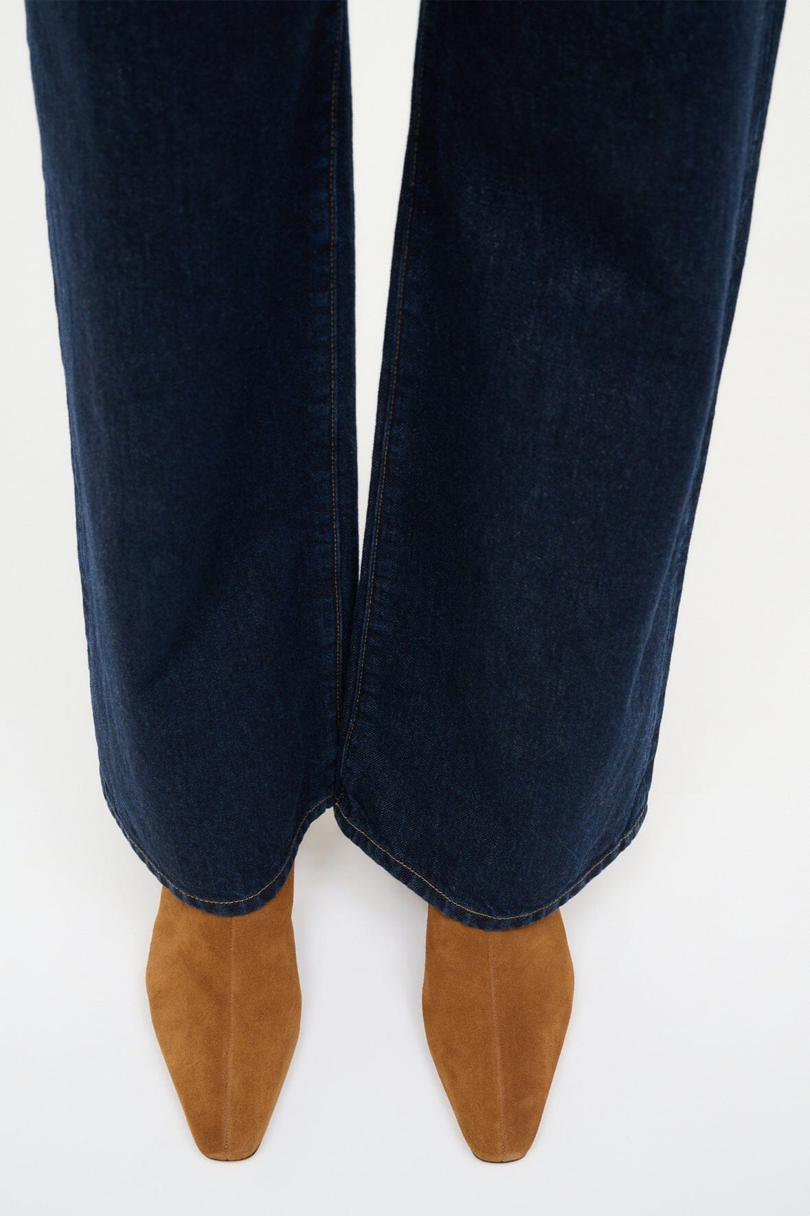 Tan suede ankle boots worn with dark blue jeans, low block heel