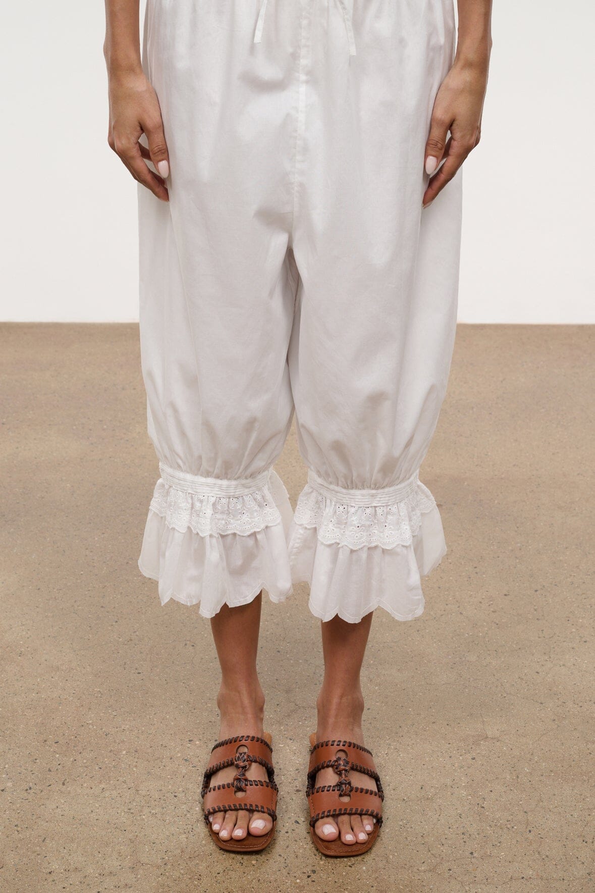 Tan slide sandals with braided straps, open toe, and stitched trim