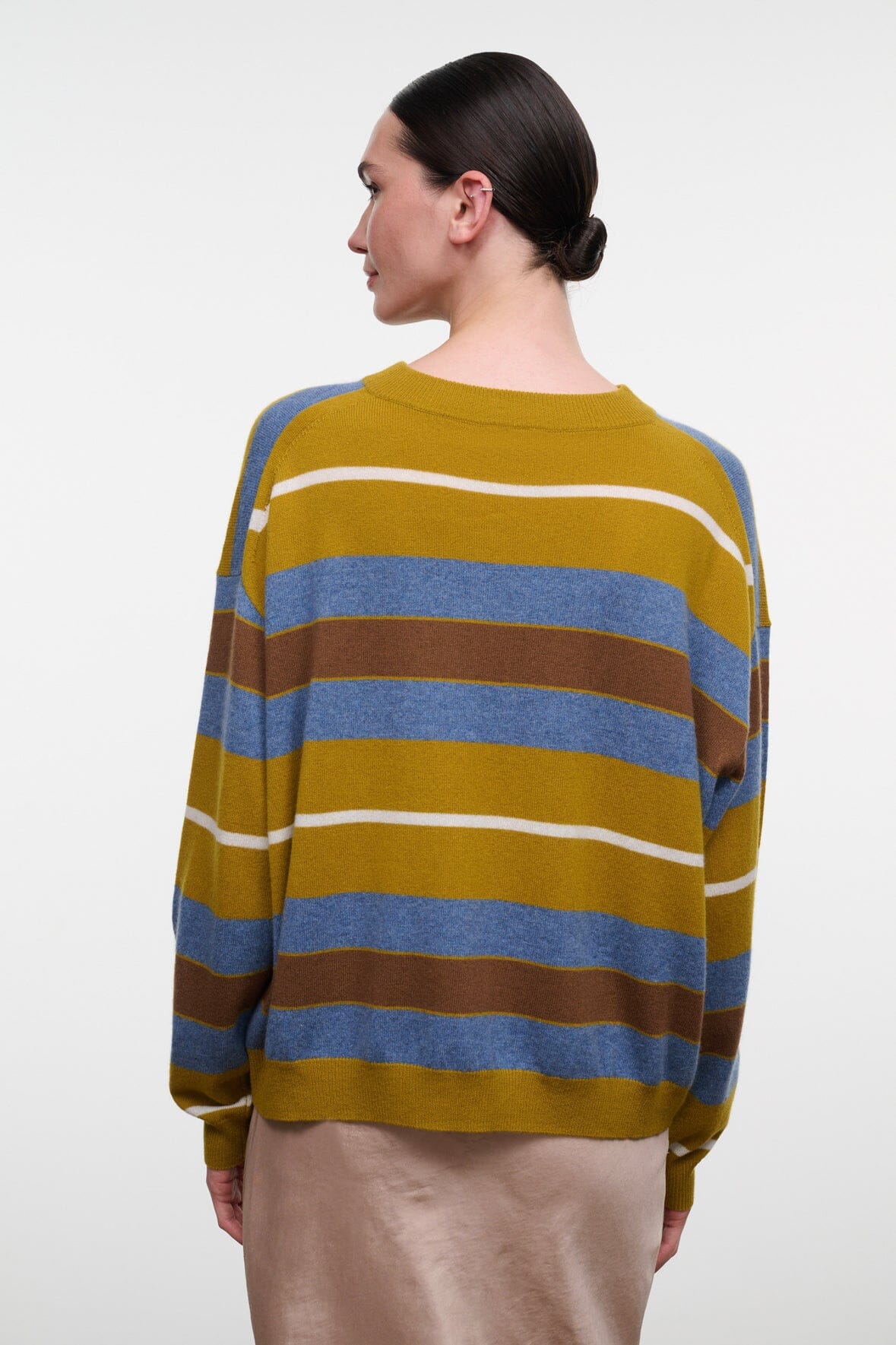 Back view of cashmere sweater with yellow and blue horizontal stripes, ribbed neckline