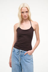 Front view of dark brown halter tank top with thin straps, worn with light blue jeans